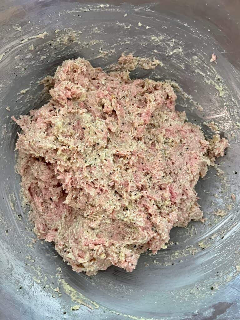 Ground turkey, ricotta cheese mixture and bread crumb mixture combined in a large mixing bowl to form the pesto turkey meatballs with ricotta cheese.