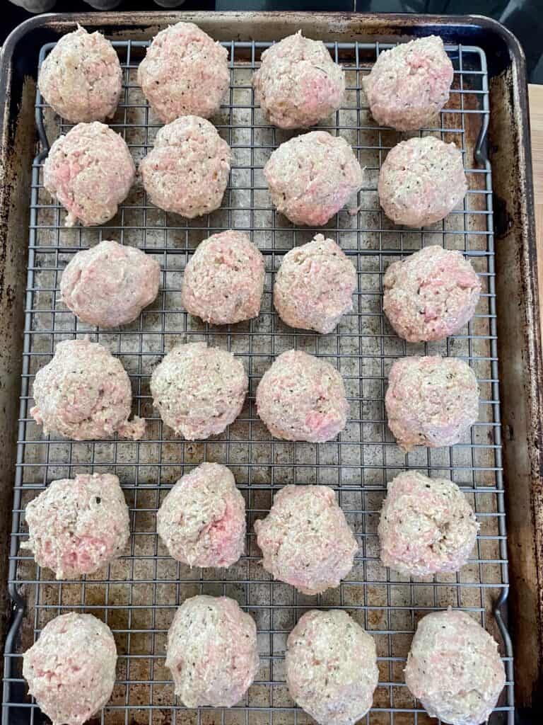 24 formed meatballs ready to go in the oven.