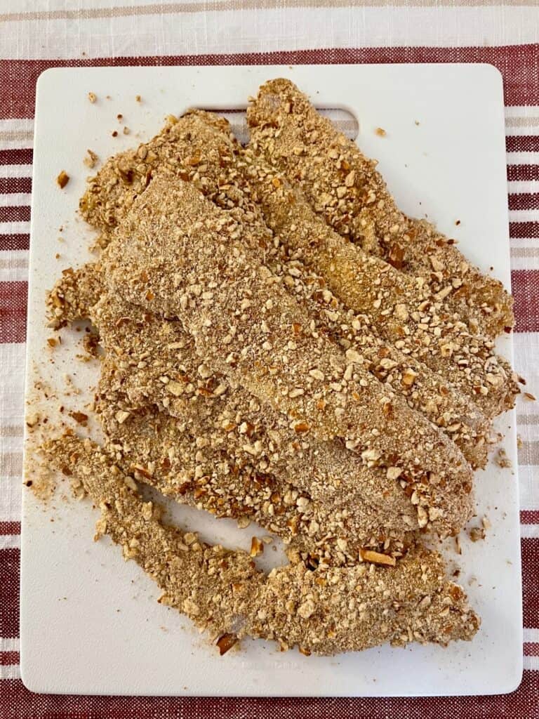 The photo shows all the chicken tenders after they have been breaded. they are now ready to start frying.