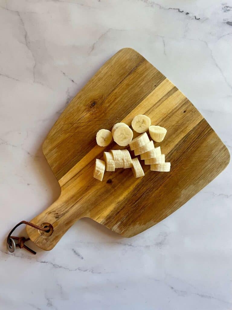 Banana sliced on a cutting board.