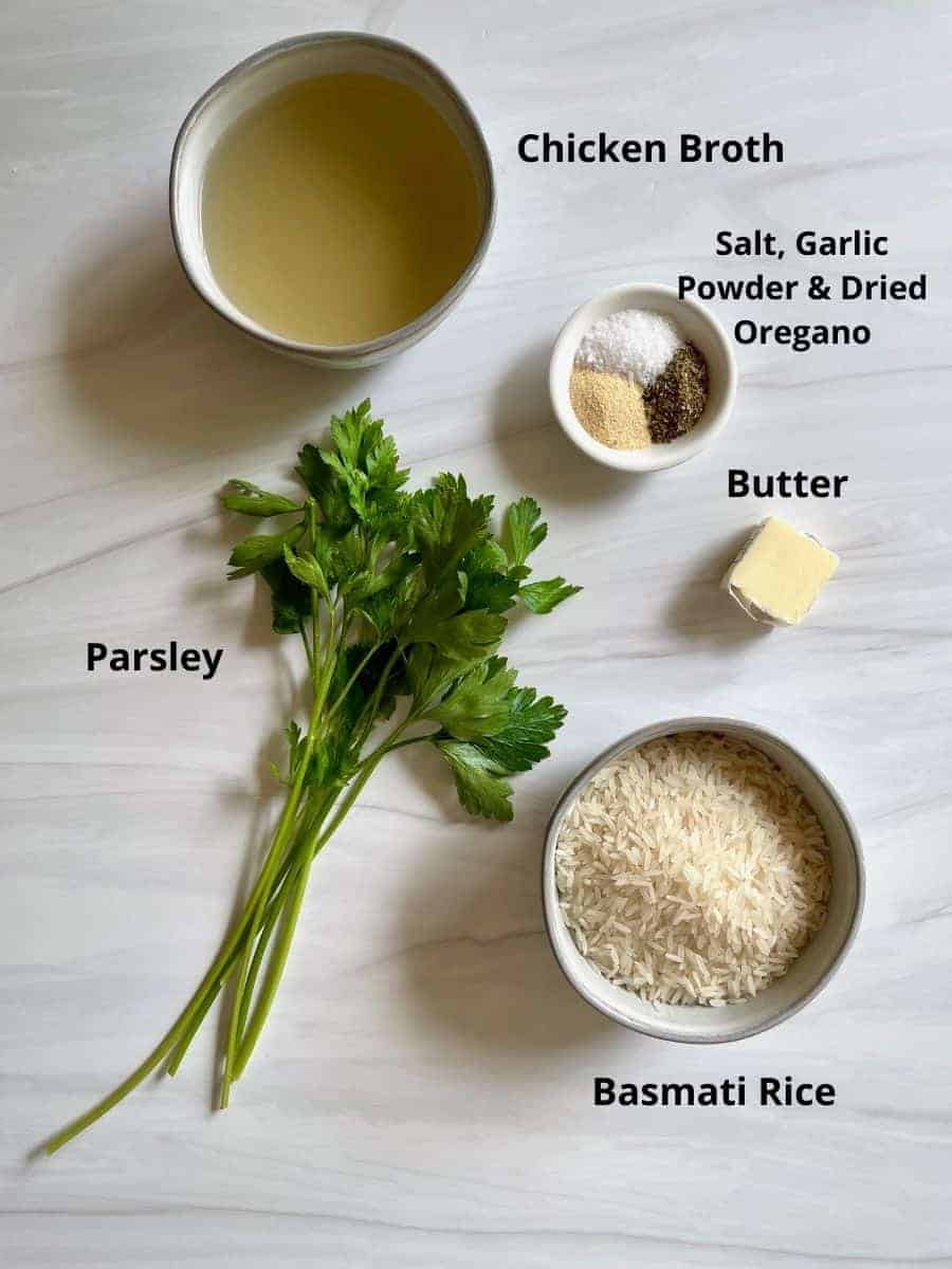 Garlic Basmati Rice ingredients labeled. The image shows low sodium chicken broth, salt, garlic powder, oregano, butter, fresh parsley and basmati rice.
