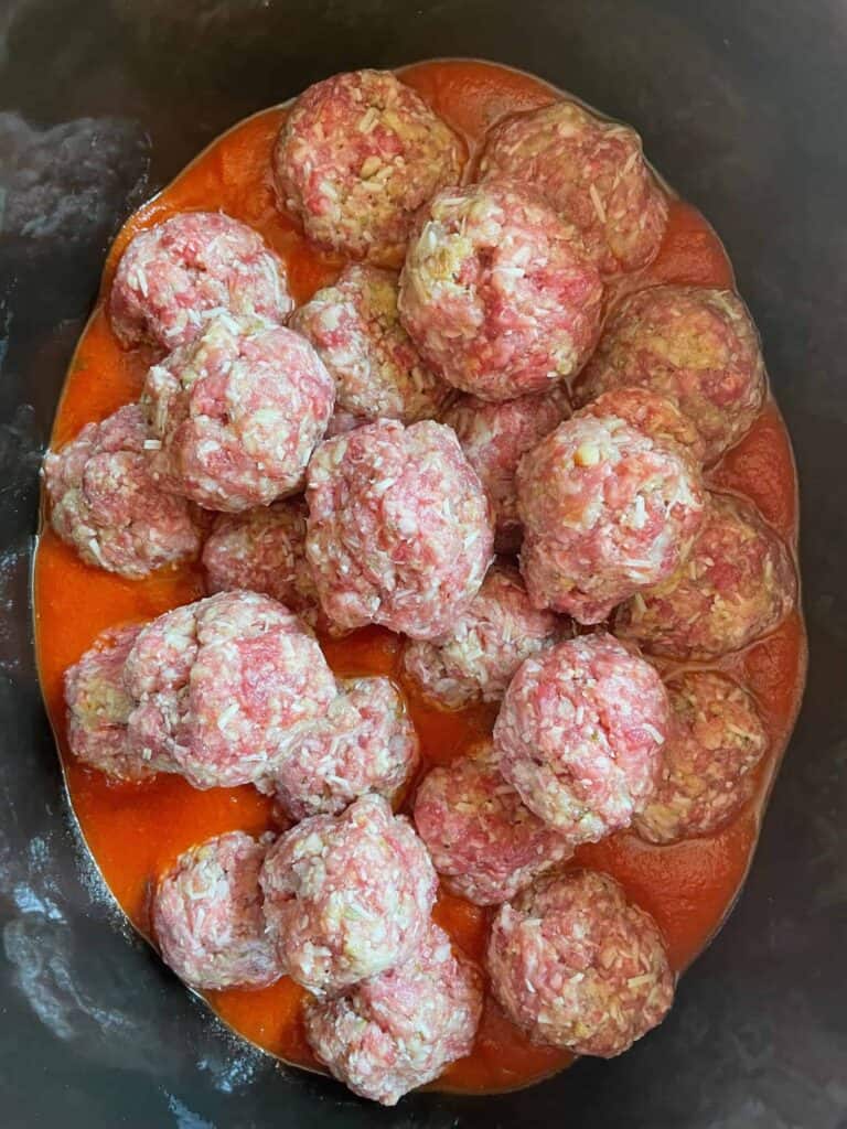 Meatballs added to the slow cooker.