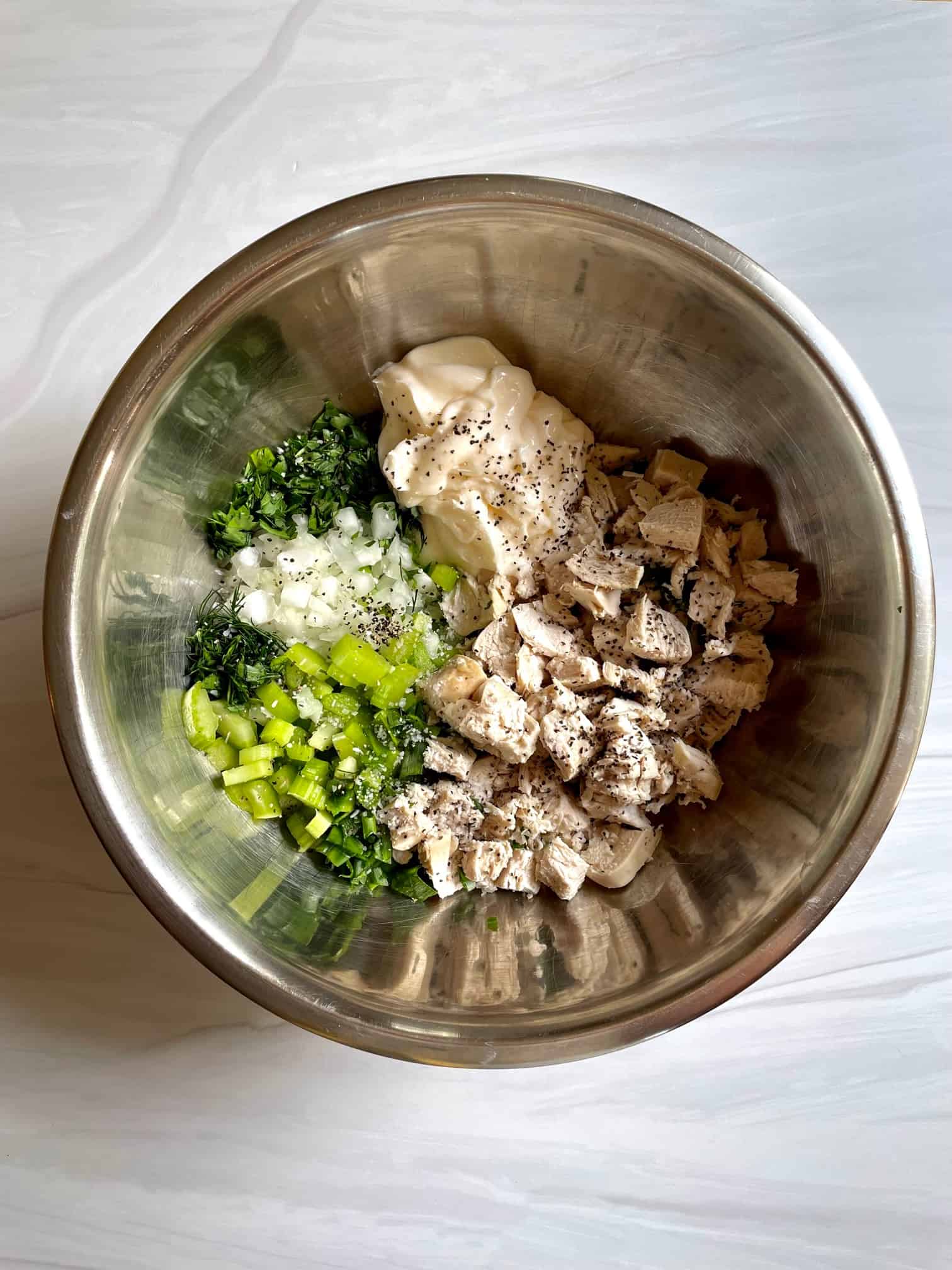 Chicken salad ingredients chopped and in a bowl ready to mix. 