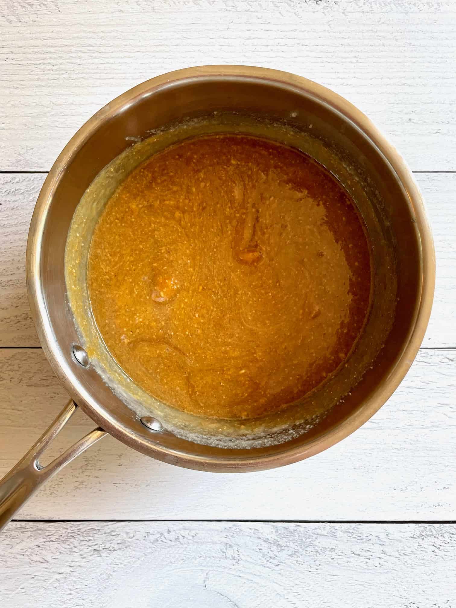 All pumpkin cookie ingredients, except for the oats, added to the sauce pan and melted/mixed together.