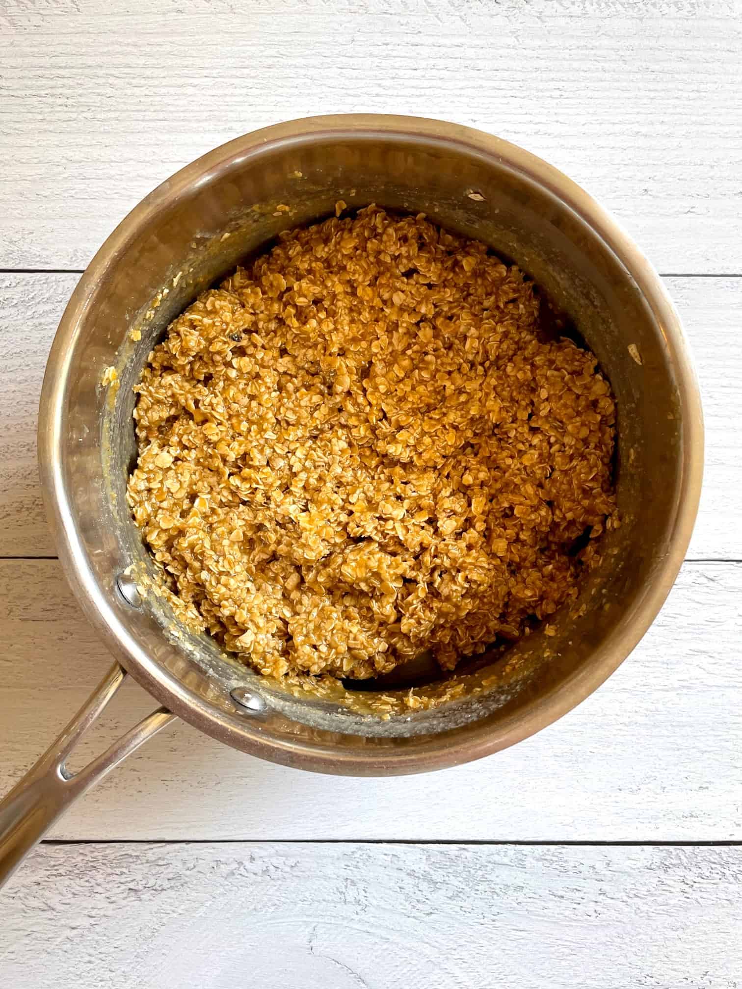All pumpkin no bake cookie ingredients mixed together in a saucepan.