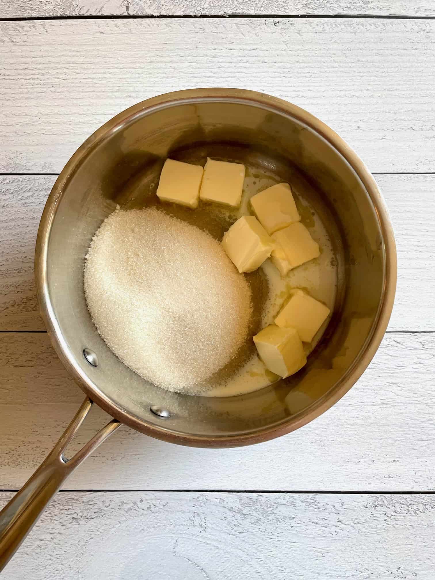 Butter, milk and sugar added to a saucepan.