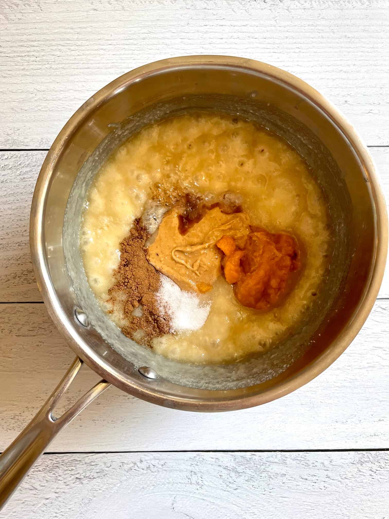 Peanut butter, pumpkin puree, salt, pumpkin pie spice and vanilla extract added to the saucepan.