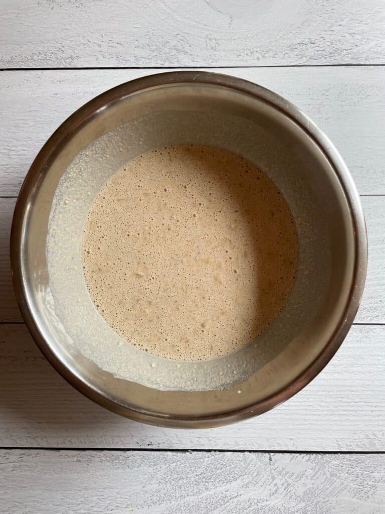 Oat flour pancake batter mixed together in a bowl.