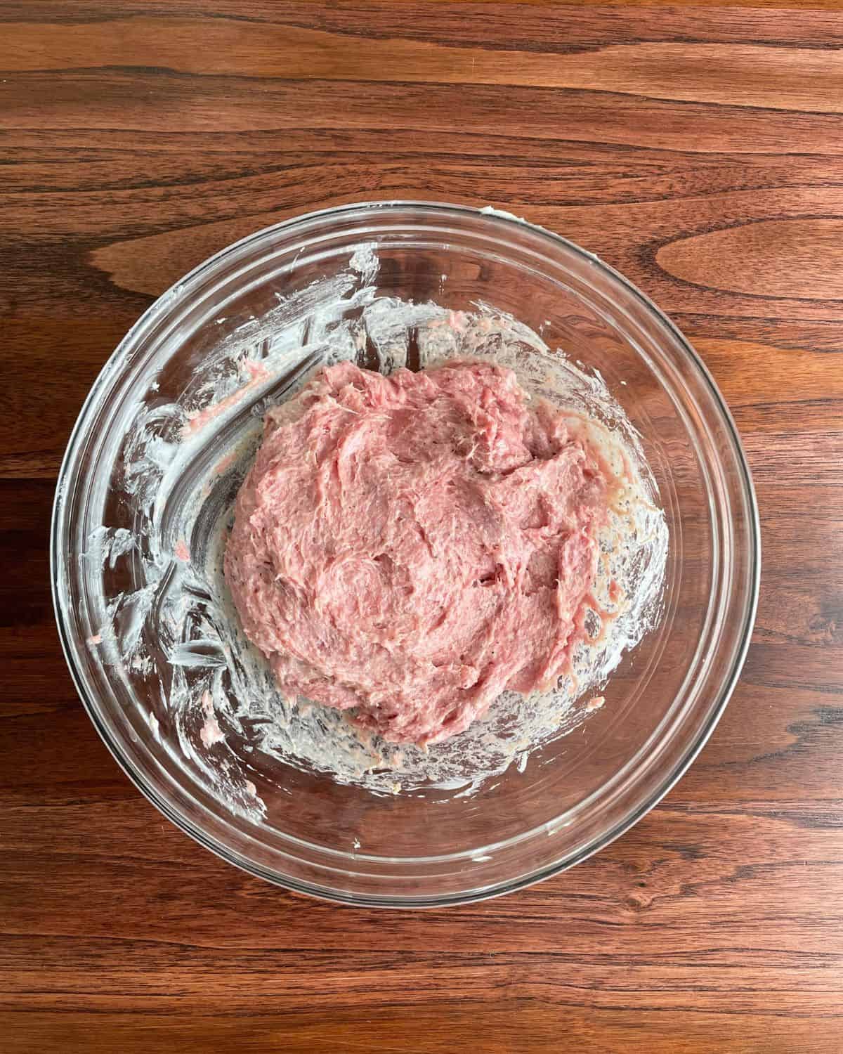 Ground turkey burger mixture in a glass bowl.