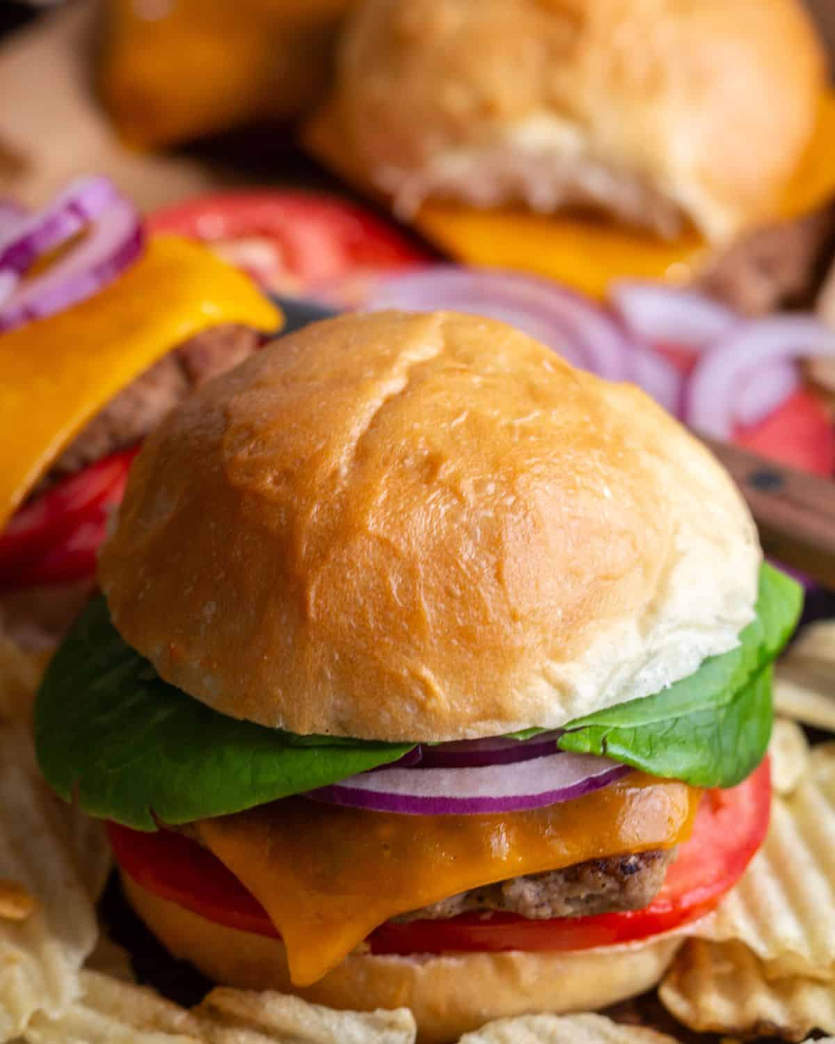 Another angle of multiple cooked turkey burgers assembled and ready to eat.