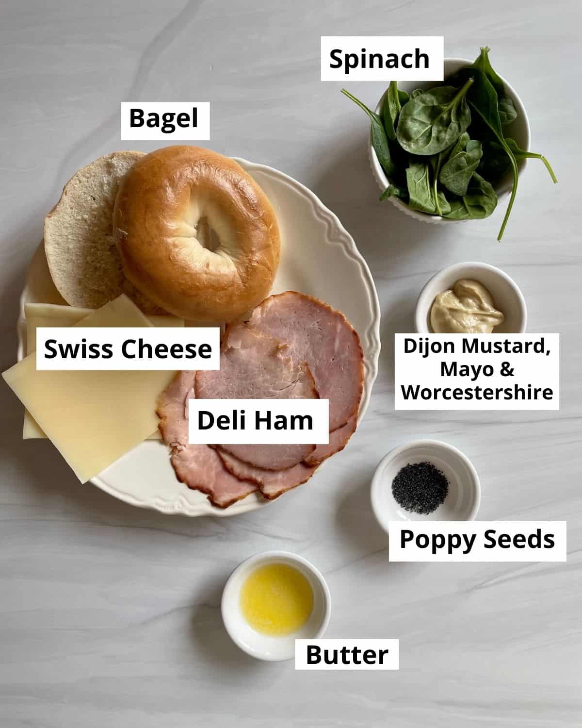 Ingredients needed to make a ham and cheese bagel sandwich.