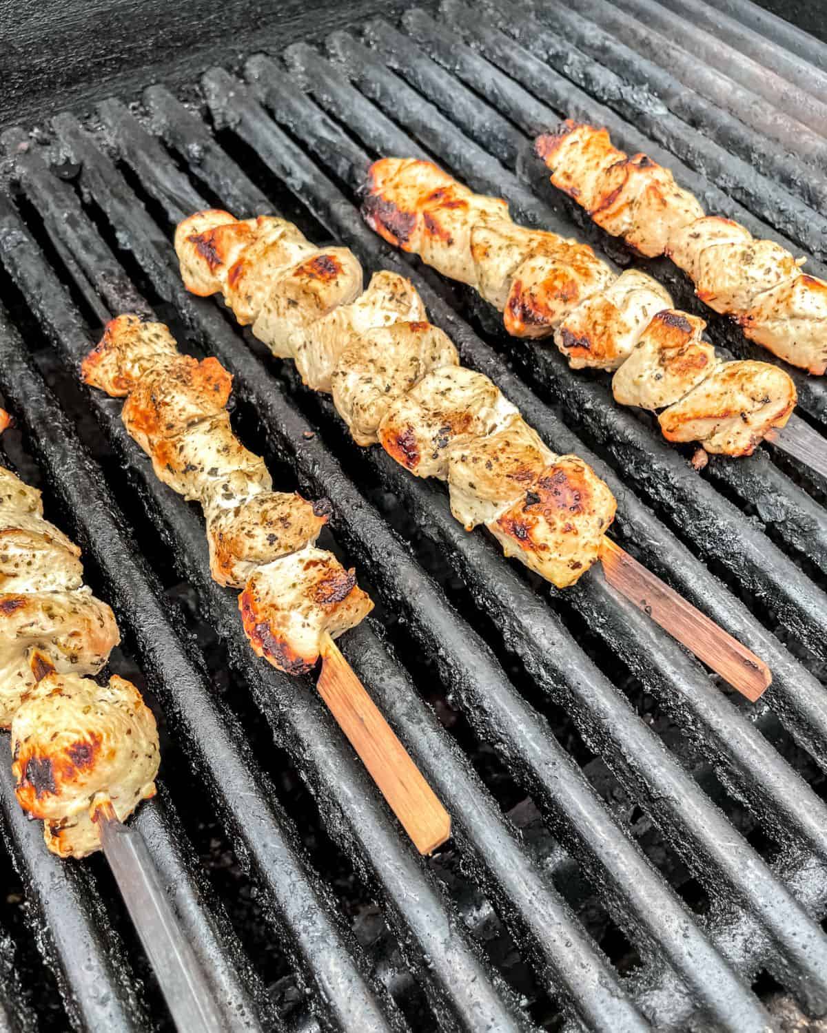Grilled chicken skewers on the grill.
