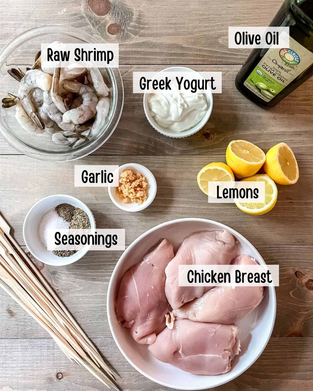 Ingredients needed to make chicken and shrimp kabobs.