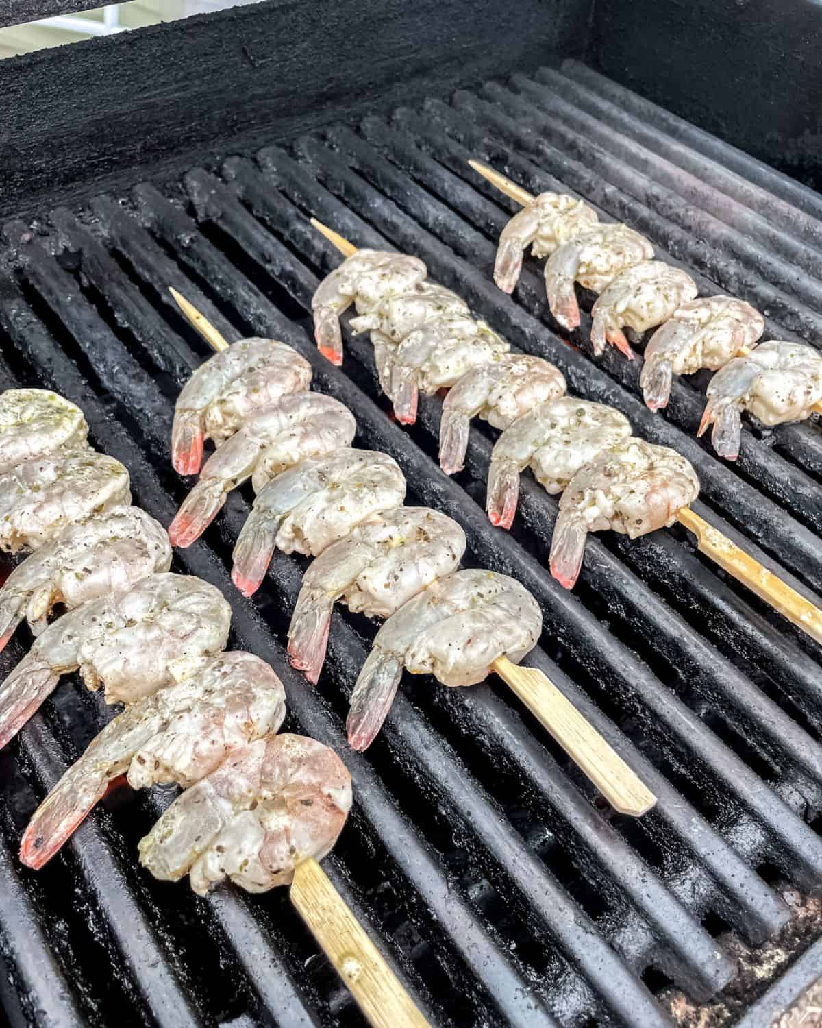 Grilled shrimp kabobs on the grill, still raw.