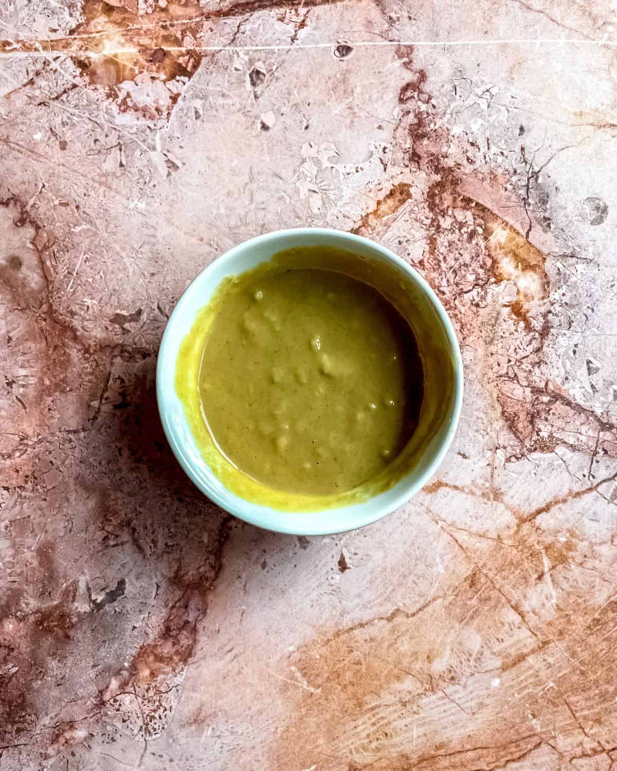 A small bowl of honey Dijon sauce.