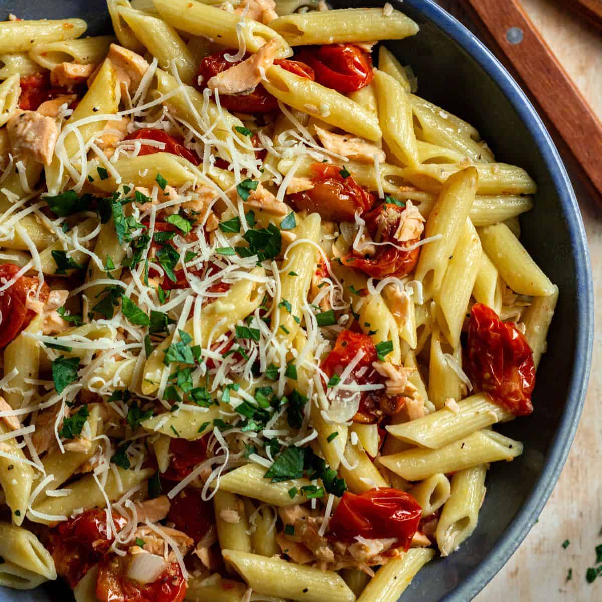 Salmon pasta without cream in a large blue bowl.