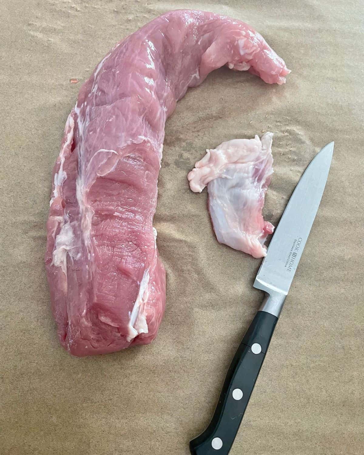 Raw pork tenderloin with the silver skin removed.