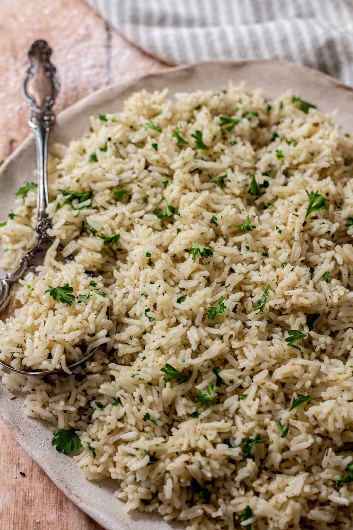 Cooked rice on a plate with a spoon.