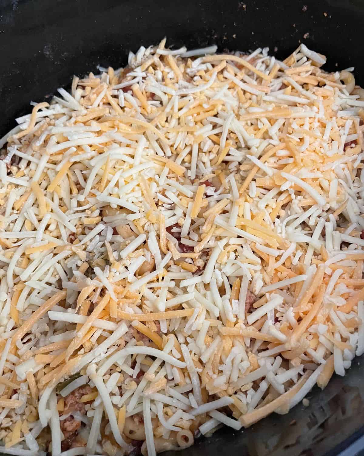 Shredded cheese on top of the slow cooker meal.