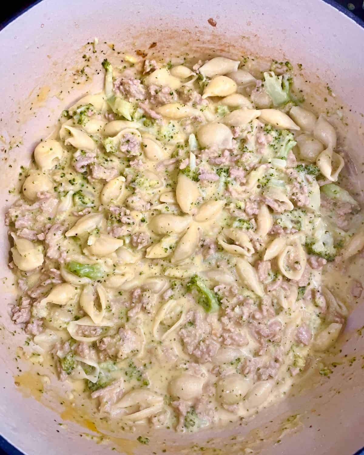 Creamy ground turkey pasta with cheese in a Dutch oven.