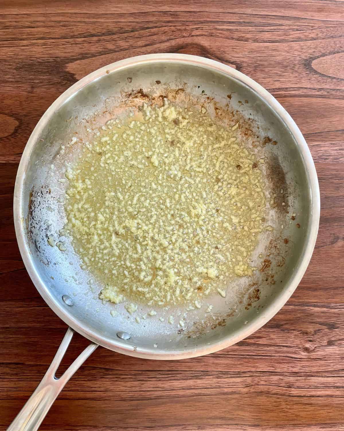 Minced garlic cooking in butter and olive oil.