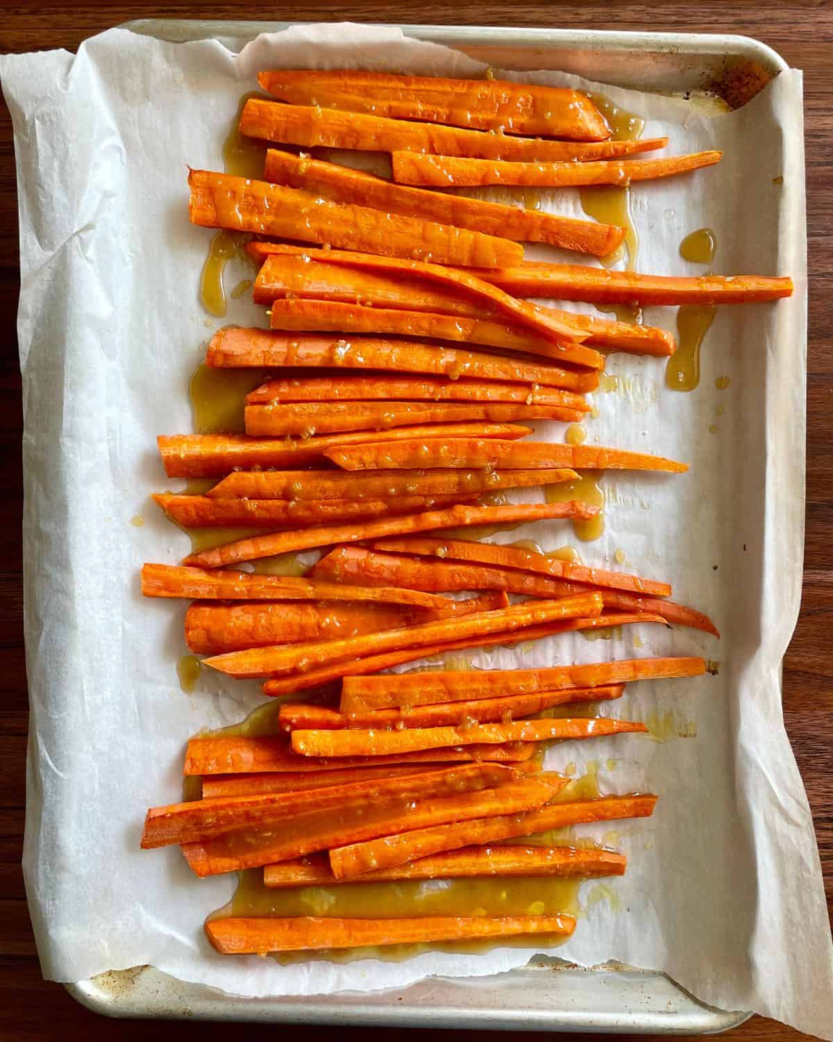 Partially baked carrots drizzled with brown sugar honey glaze.