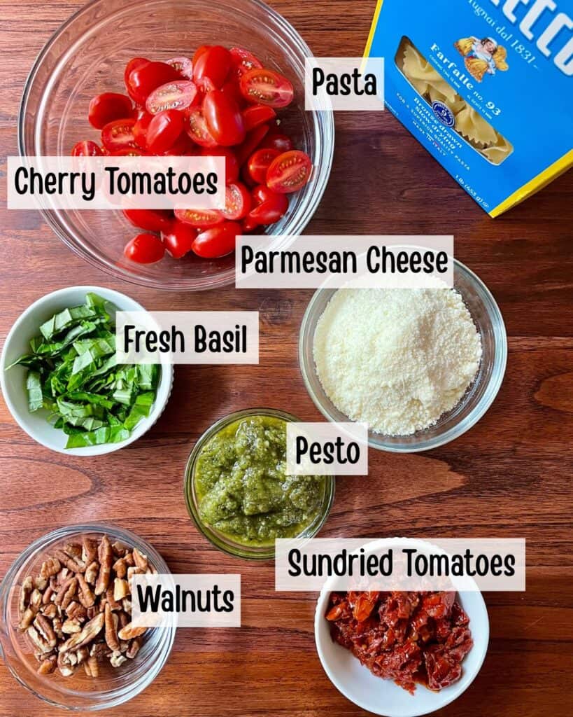 Ingredients needed to make pesto pasta salad measured out and in bowls.
