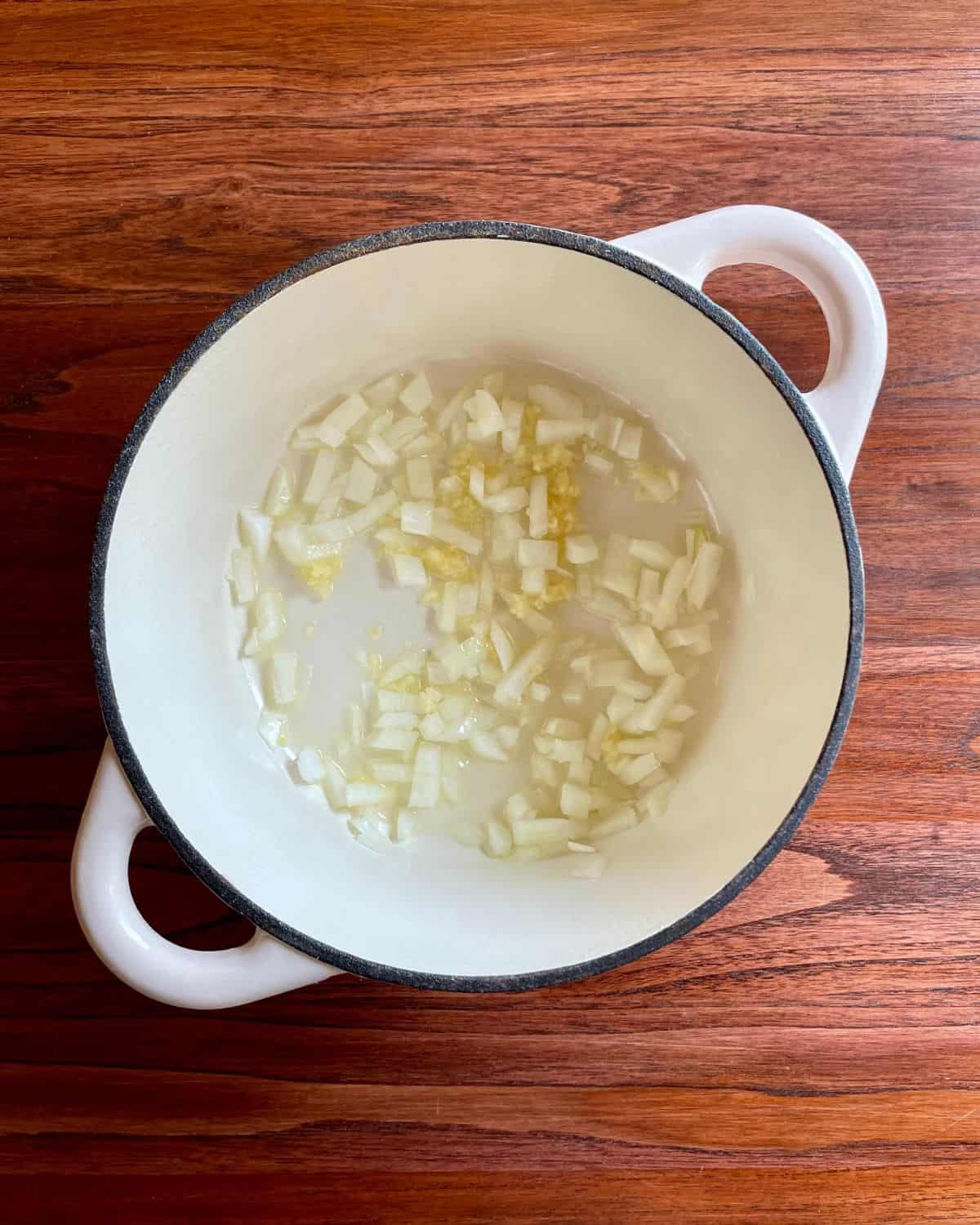 Onions and garlic cooking in a pot.