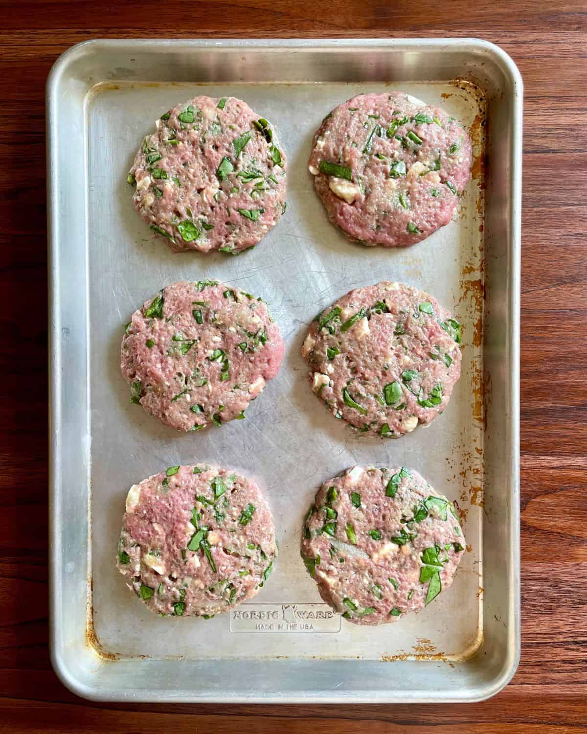 Formed turkey burgers on a pan.
