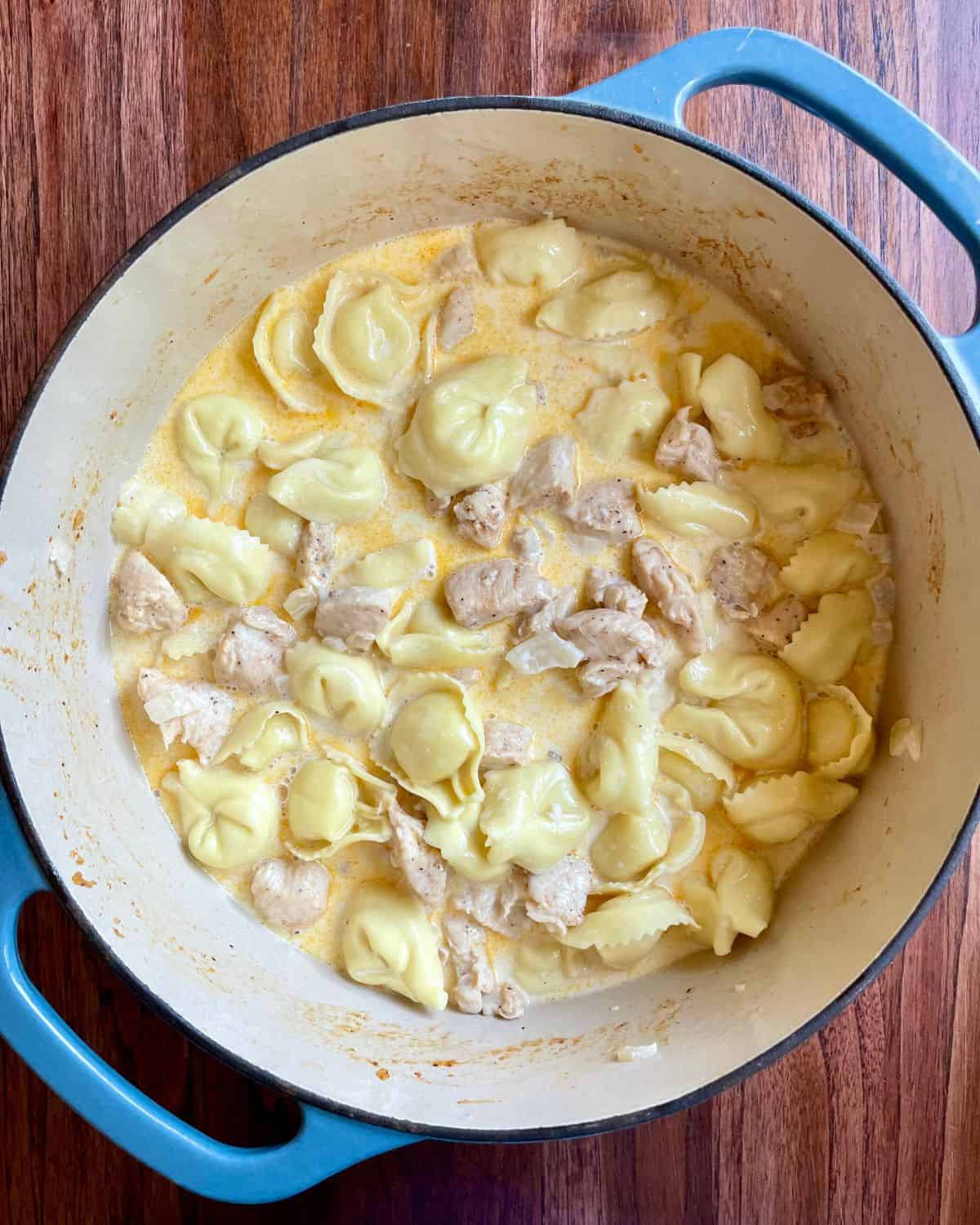 Chicken stirred back into the creamy tortellini.