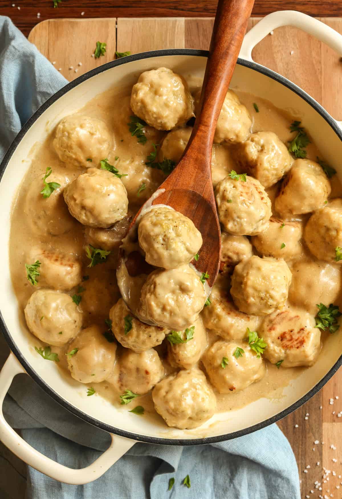 Ground chicken meatballs in a skillet with Swedish meatball gravy.