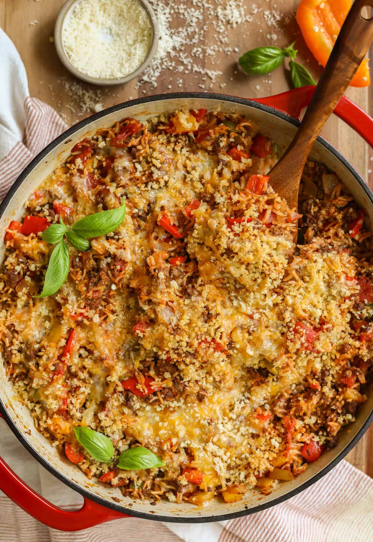 Stuffed pepper skillet recipe cooked and ready to serve, garnished with fresh basil and extra parmesan cheese.