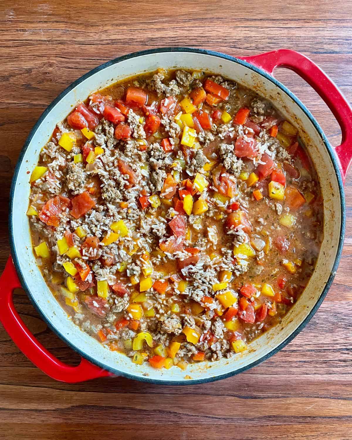 Dry rice mixed into the ground beef and peppers mixture.