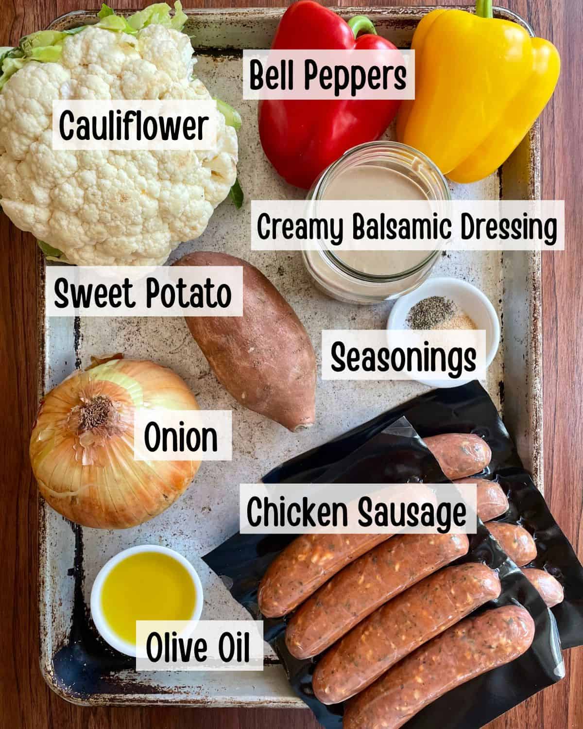 Ingredients needed to make a chicken sausage and veggies on a sheet pan.