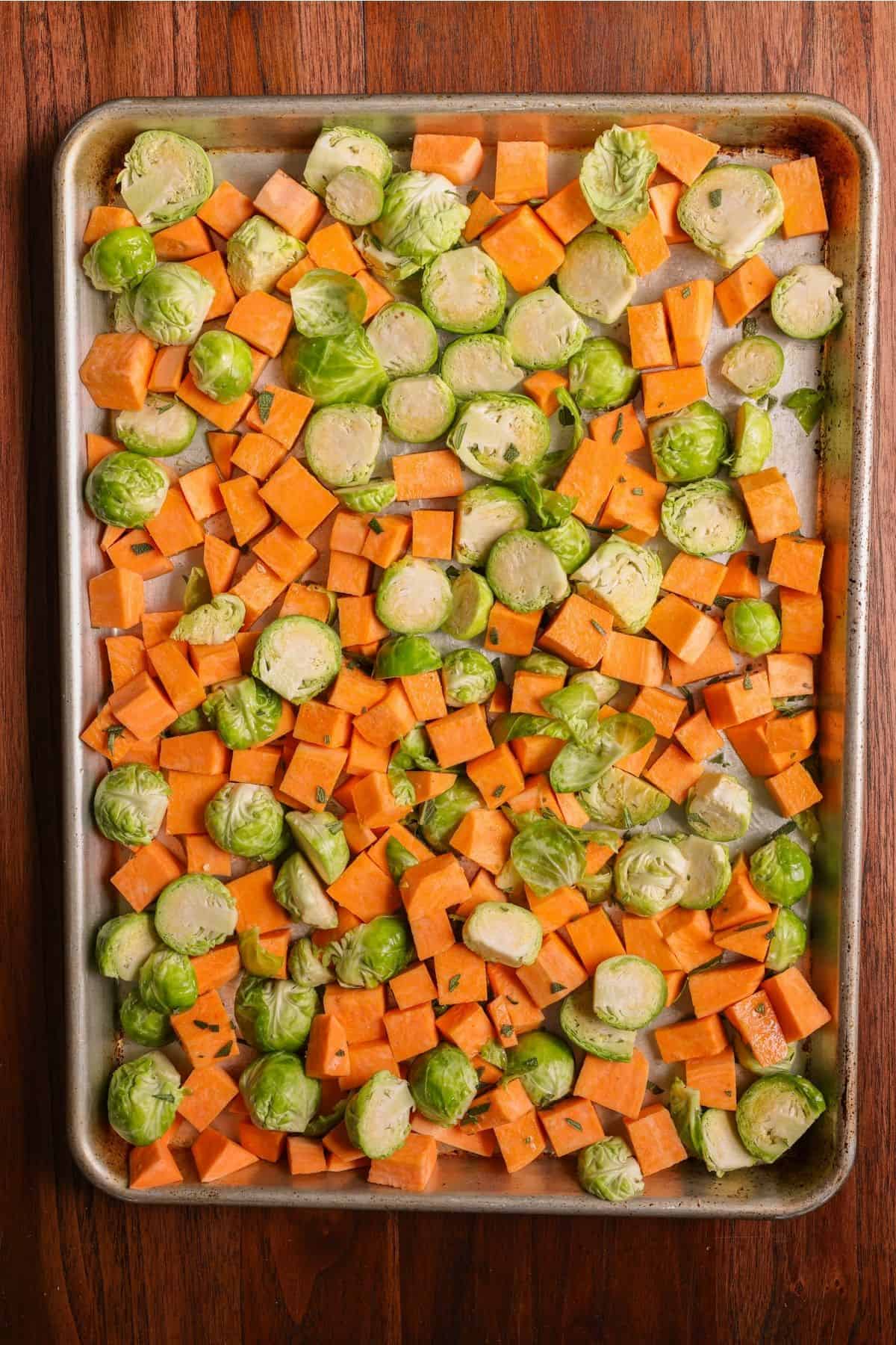 Chopped and seasoned veggies on a sheet pan.
