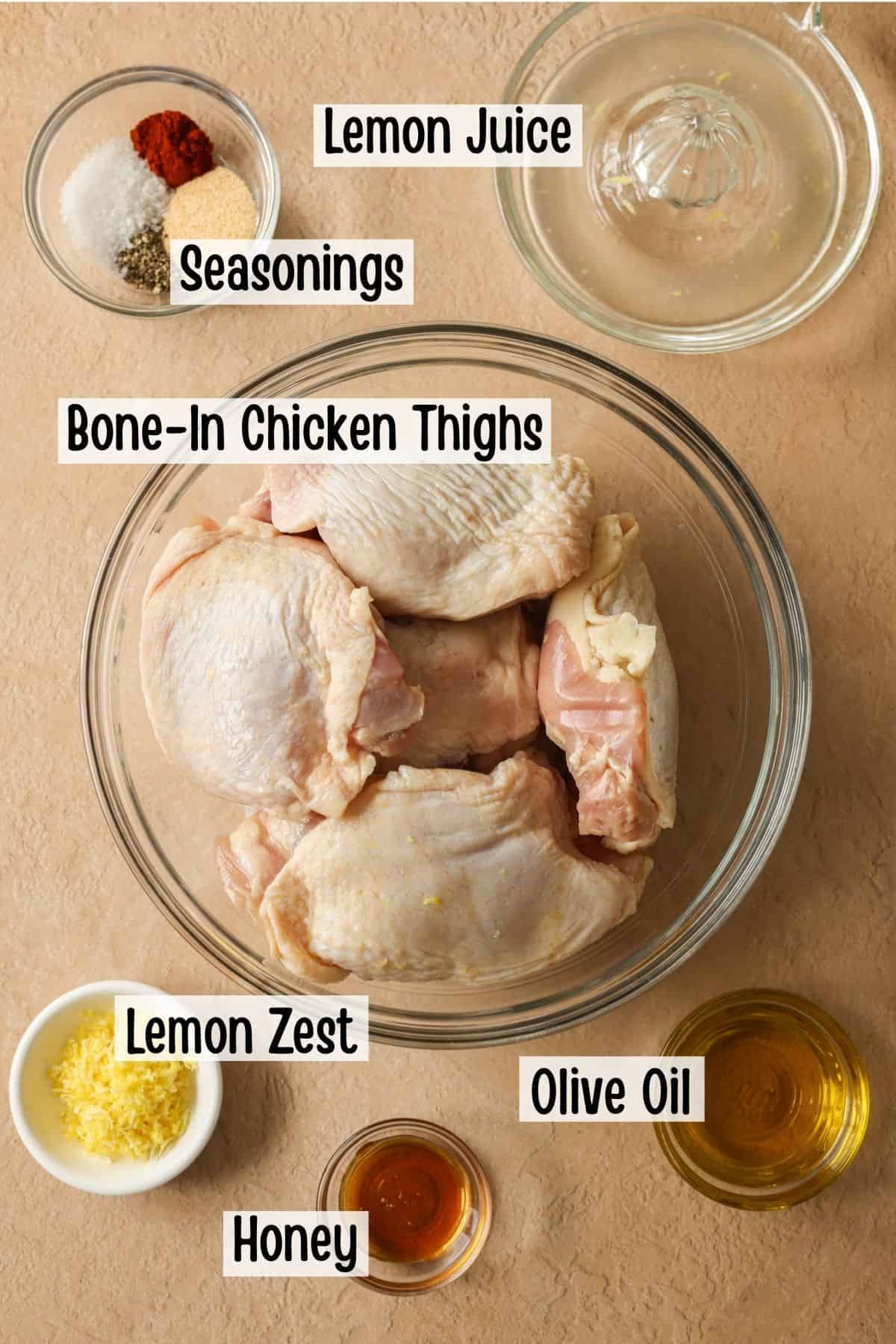 Ingredients needed to make chicken thighs seasoned with a homemade lemon pepper blend.