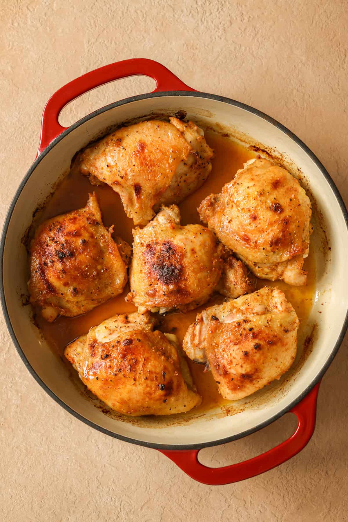 Lemon pepper chicken thighs in a baking dish, right after they have come out of the oven.
