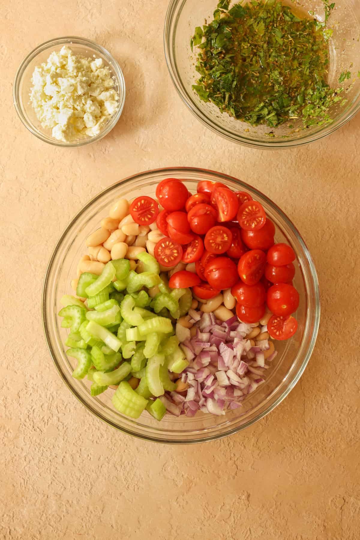 All of the salad components and prepared and in dishes, ready to be combined.