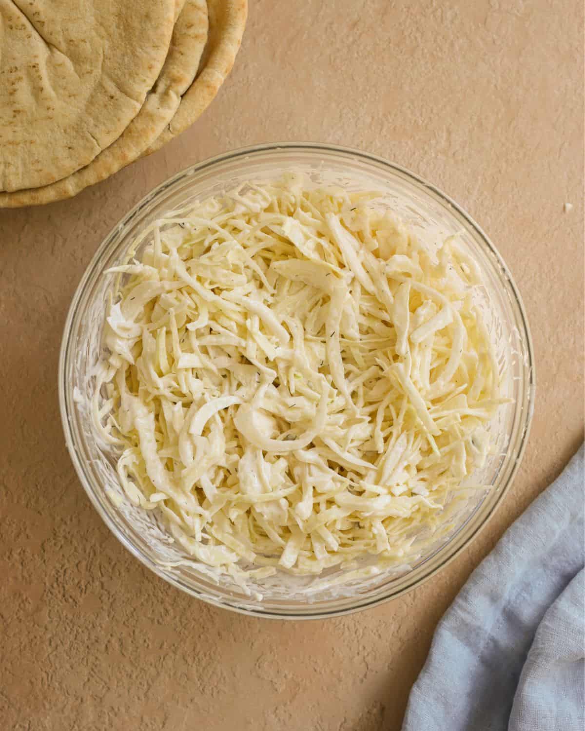 Shredded cabbage mixed with Tzatziki sauce to make a slaw.