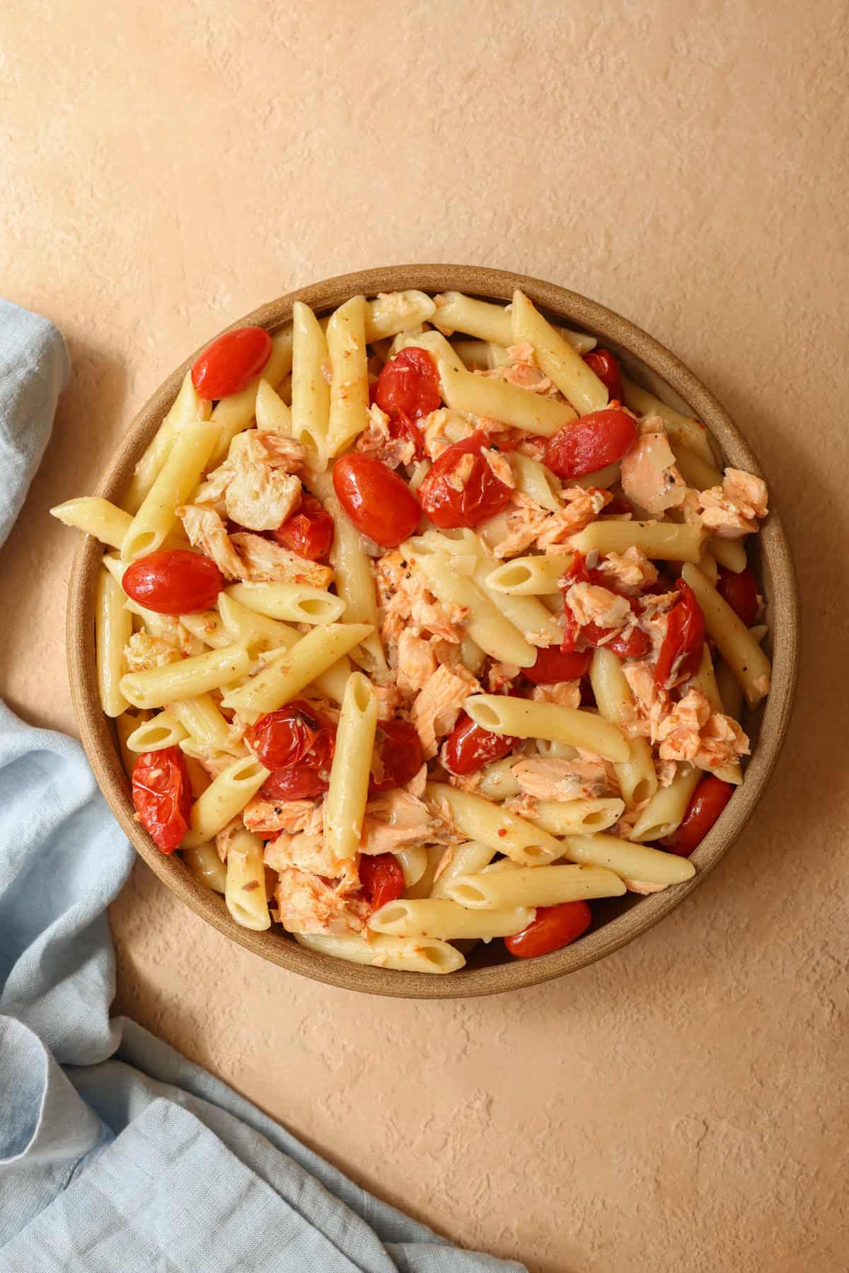 A photo showing the finished recipe for no cream salmon pasta with cherry tomatoes and butter sauce.