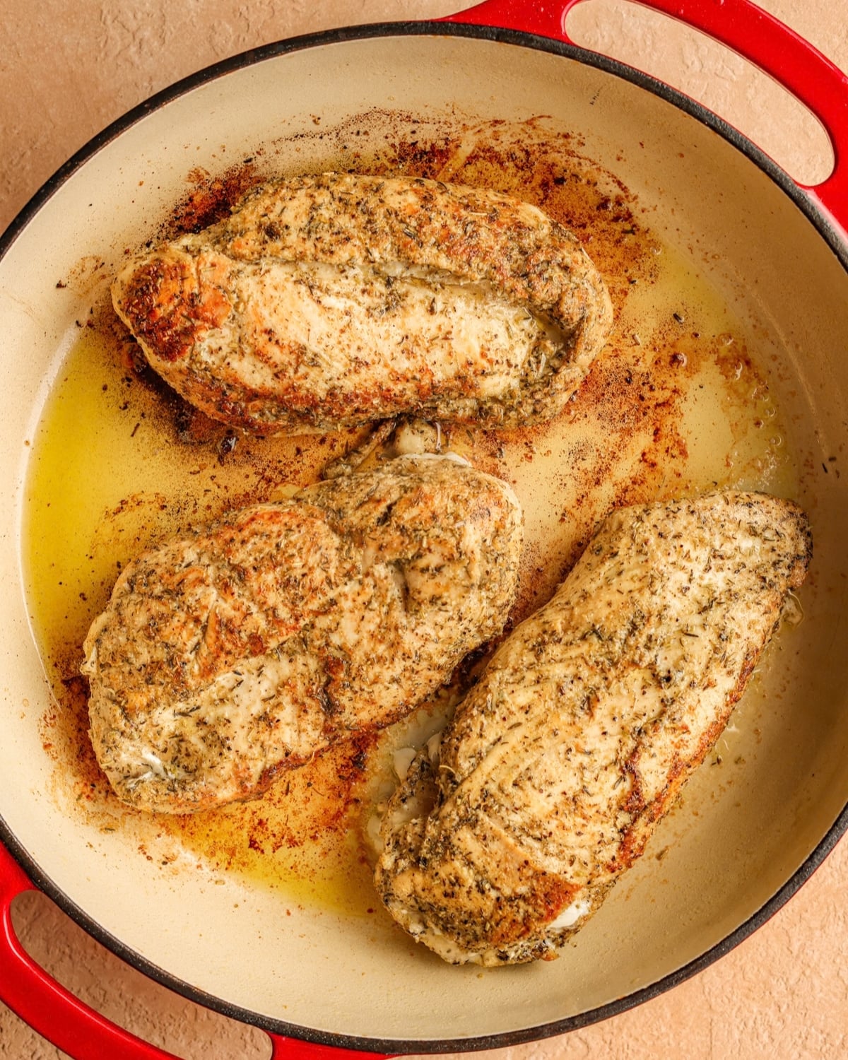 Seared chicken breasts in a skillet.
