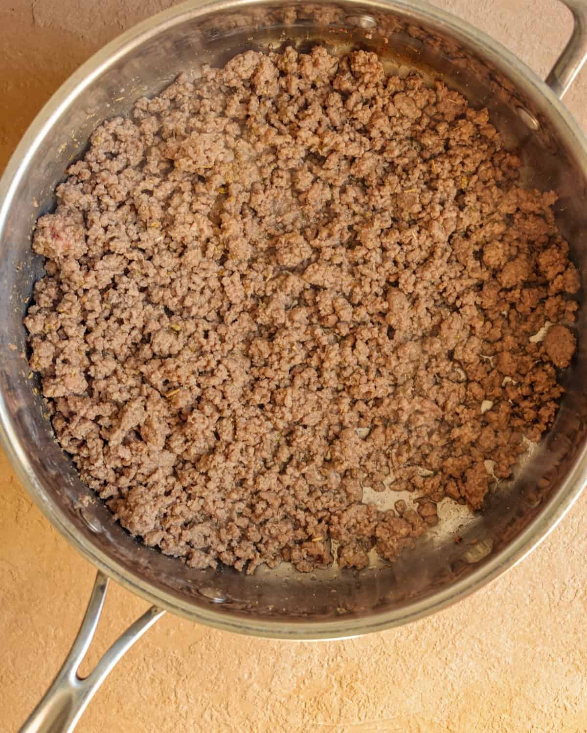 Cooked ground beef in a skillet.