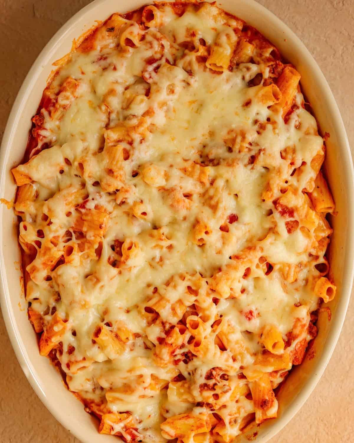 Baked ziti topped with mozzarella cheese and baked until melty.