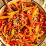 Cooked ground pork sausage and peppers in a skillet.