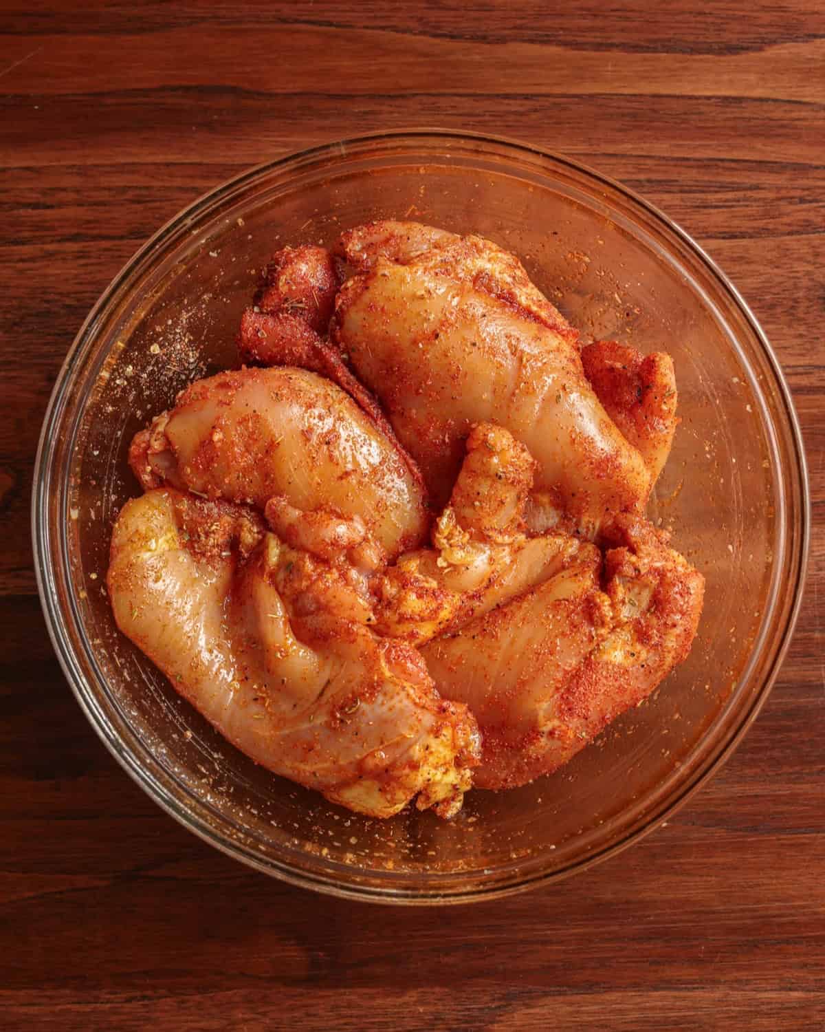 Boneless chicken thighs covered in a seasoning blend.