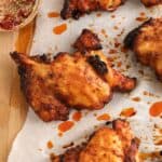 Up close image of a boneless chicken thigh that has been rubbed in a seasoning blend and air fried.