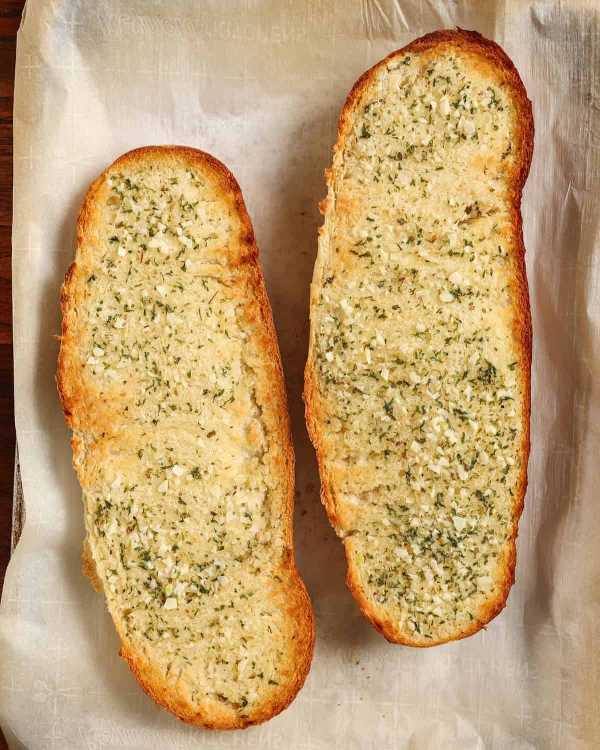 A loaf of Italian bread sliced open lengthwise, slathered in garlic butter and broiled until crisp.
